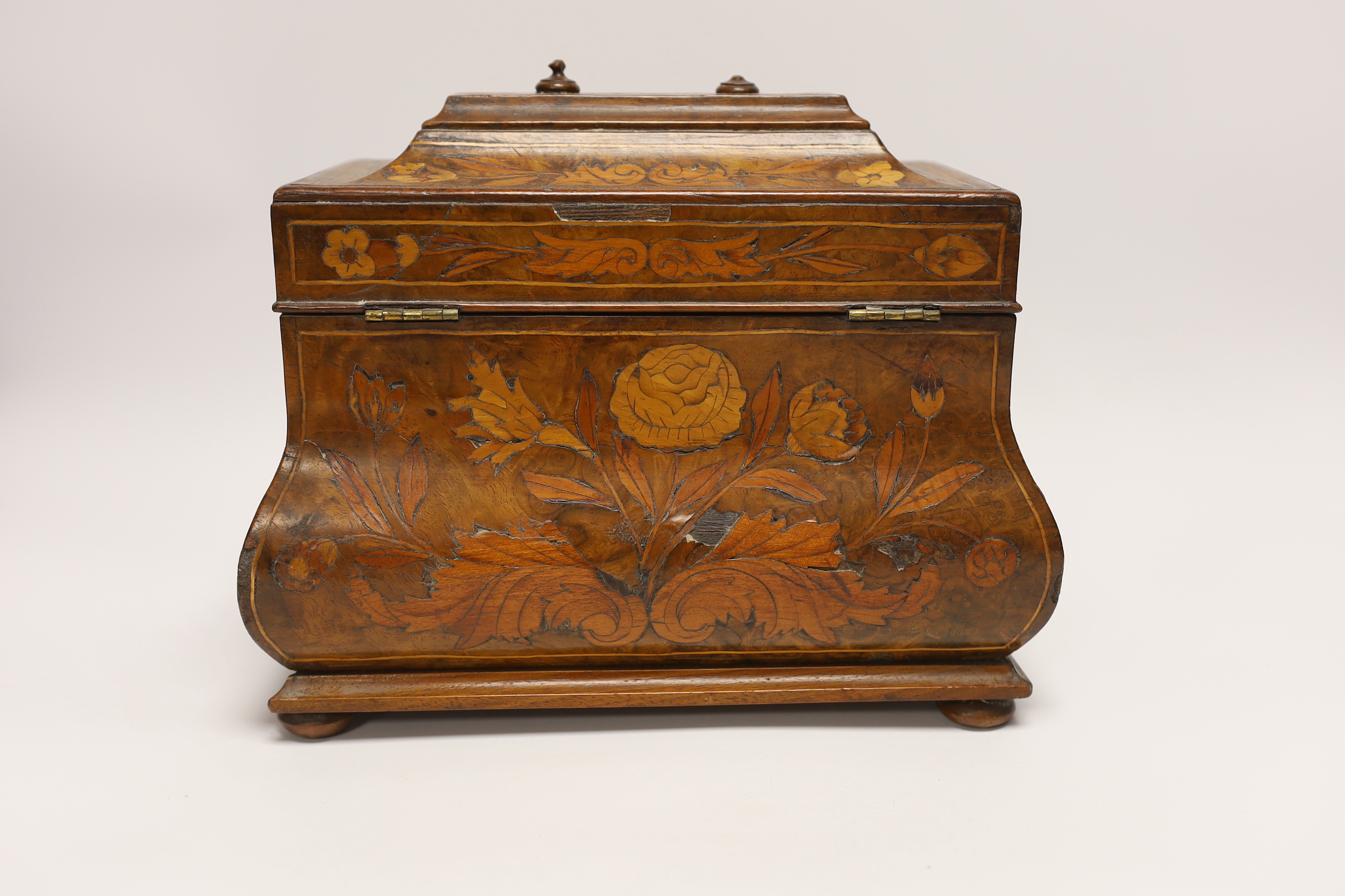 An 18th century Dutch floral marquetry bombé shaped tea caddy, 26cm wide